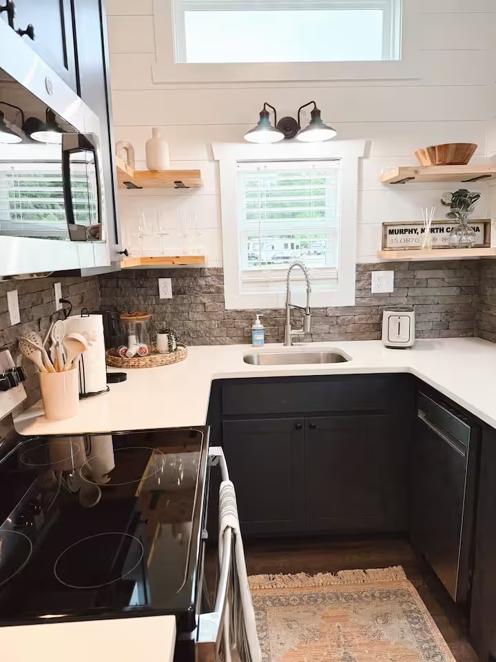 Tiny Timber kitchen sink and range with stone backsplash and Murphy, NC sign