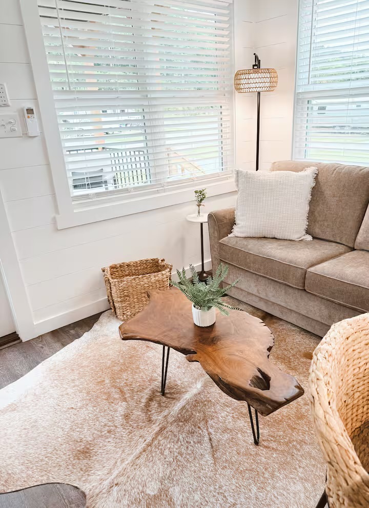 Tiny Timber living area with live-edge coffee table and woven accents