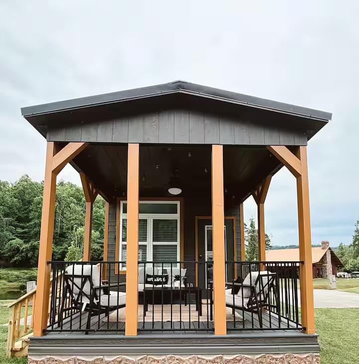 Tiny Timber exterior front with covered porch, timber posts, and railings