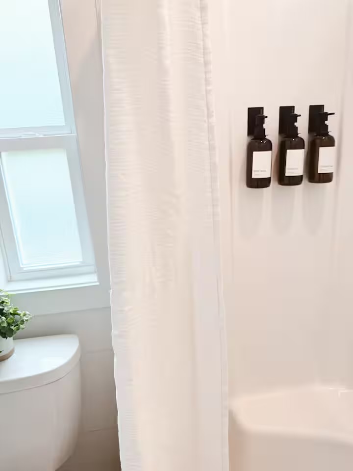 Tiny Timber shower with wall-mounted amenity dispensers